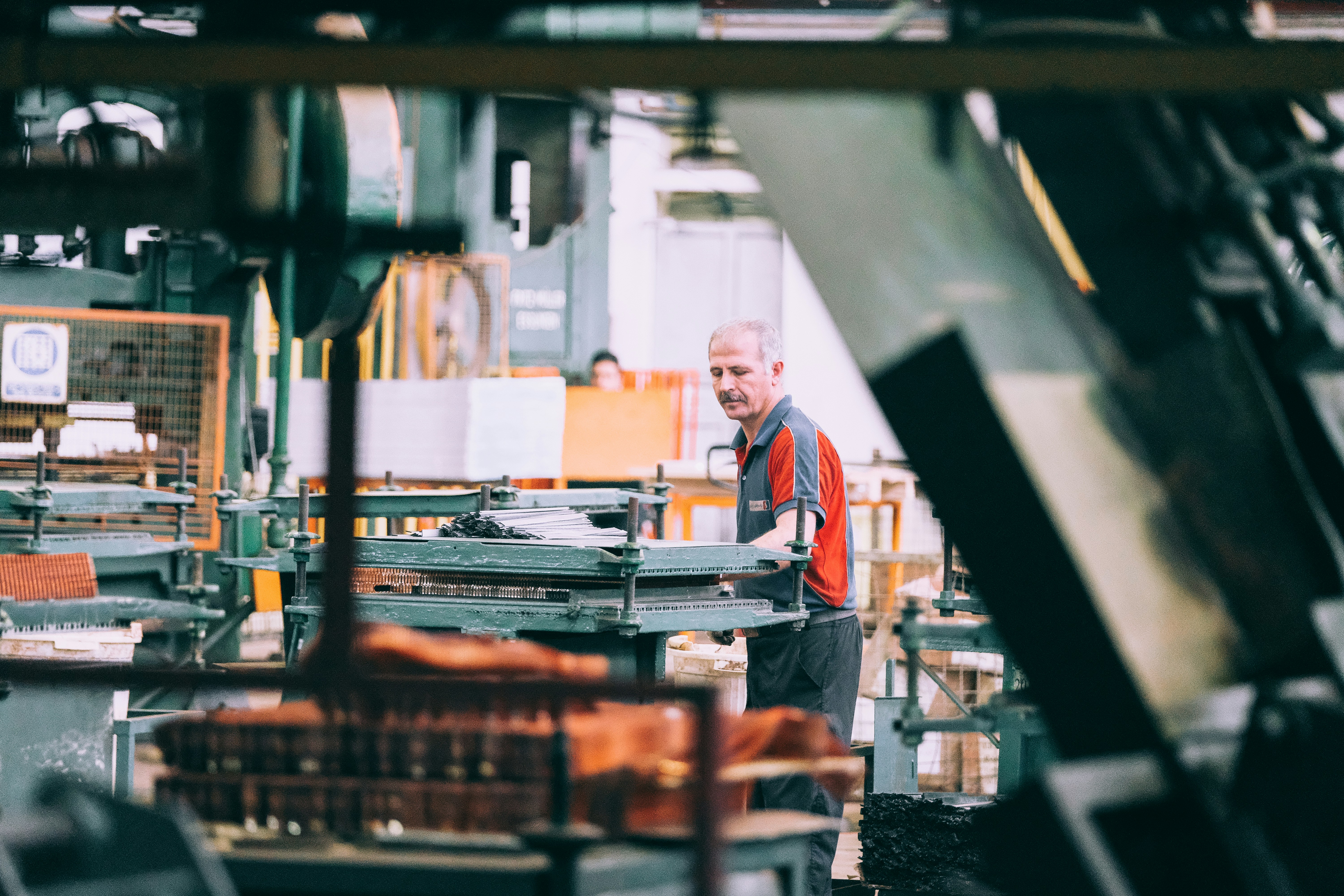 Factory floor worker operating heavy machinery